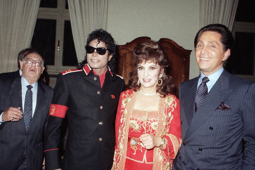 Lollobrigida poses with Michael Jackson and fashion designer Valentino