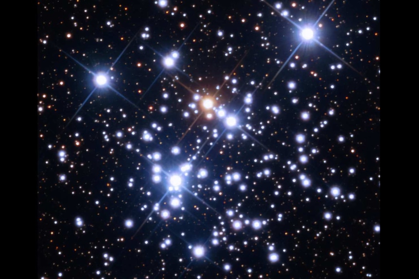 A cluster of bright stars, including some white and some redder stars.