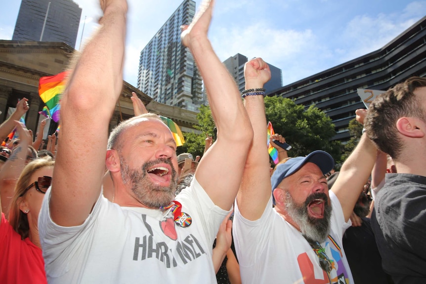 Friends Paul Keith and Kevin Roadknight applaud the decision in Melbourne.