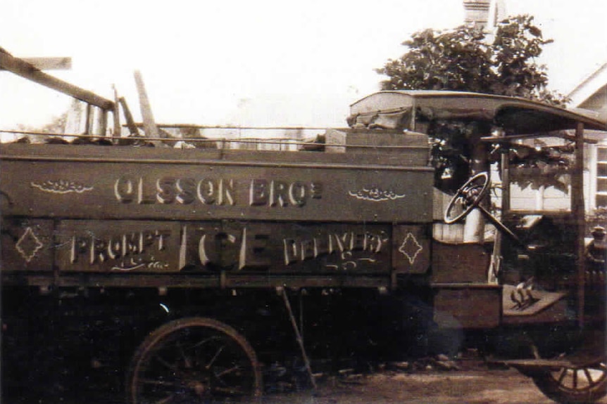 An old photo of an ice delivery truck which reads "Olsson Bros prompt ice delivery"