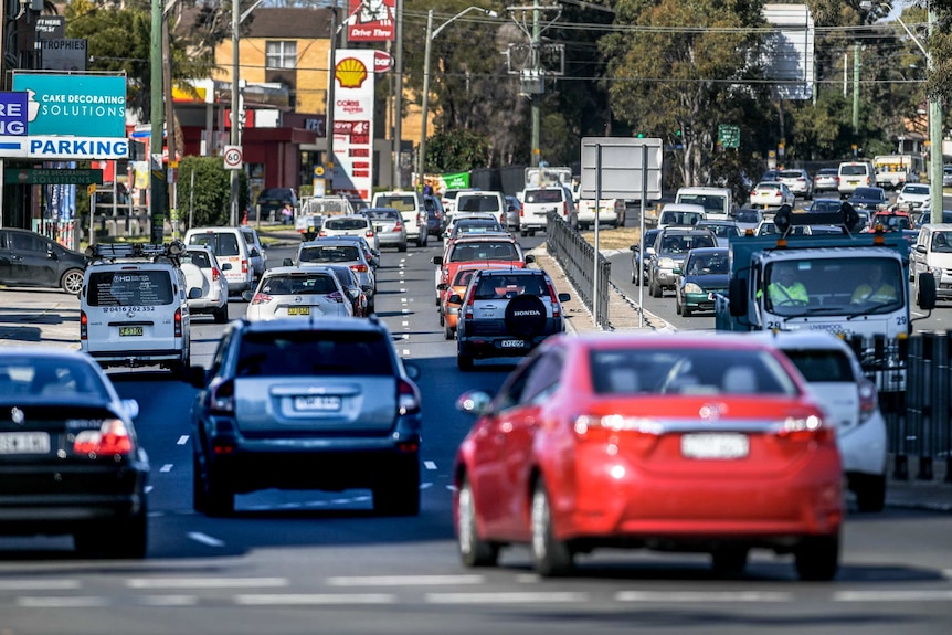 Three lanes of cars in traffic shot from behind on the Hume Highway in Liverpool, NSW.