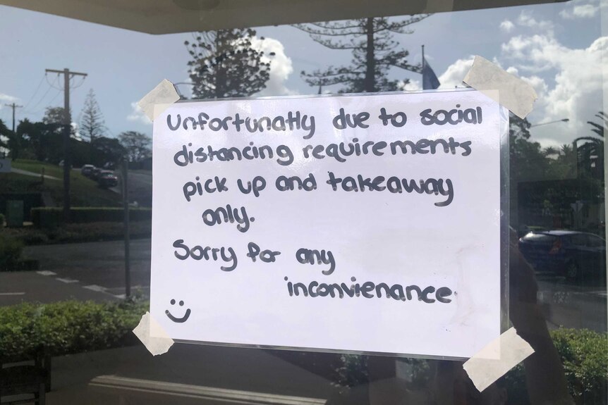 A sign on a restaurant window telling people they are only open for deliveries.
