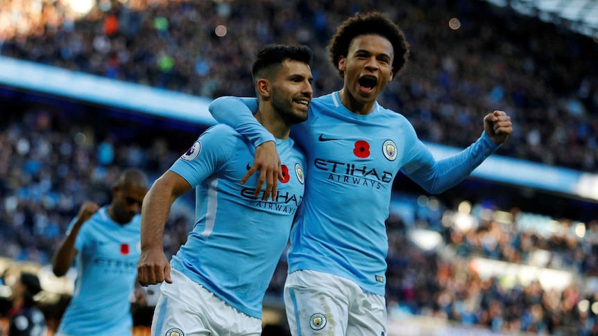 Sergio Aguero and Leroy Sane with their arms around each other after a goal for Manchester City against Arsenal.