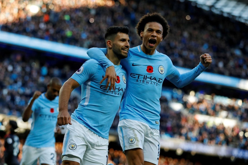 Sergio Aguero and Leroy Sane with their arms around each other after a goal for Manchester City against Arsenal.