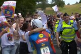Julien Bernard kisses his wife as crowds of people watch on