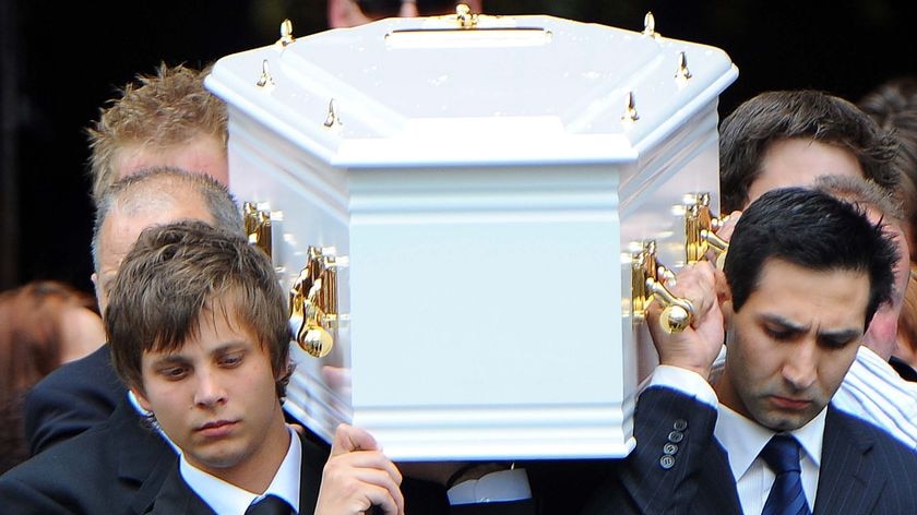 Blake Cassidy (front left) carries the coffin of his brother Tyler Cassidy with other unidentified pallbearers.