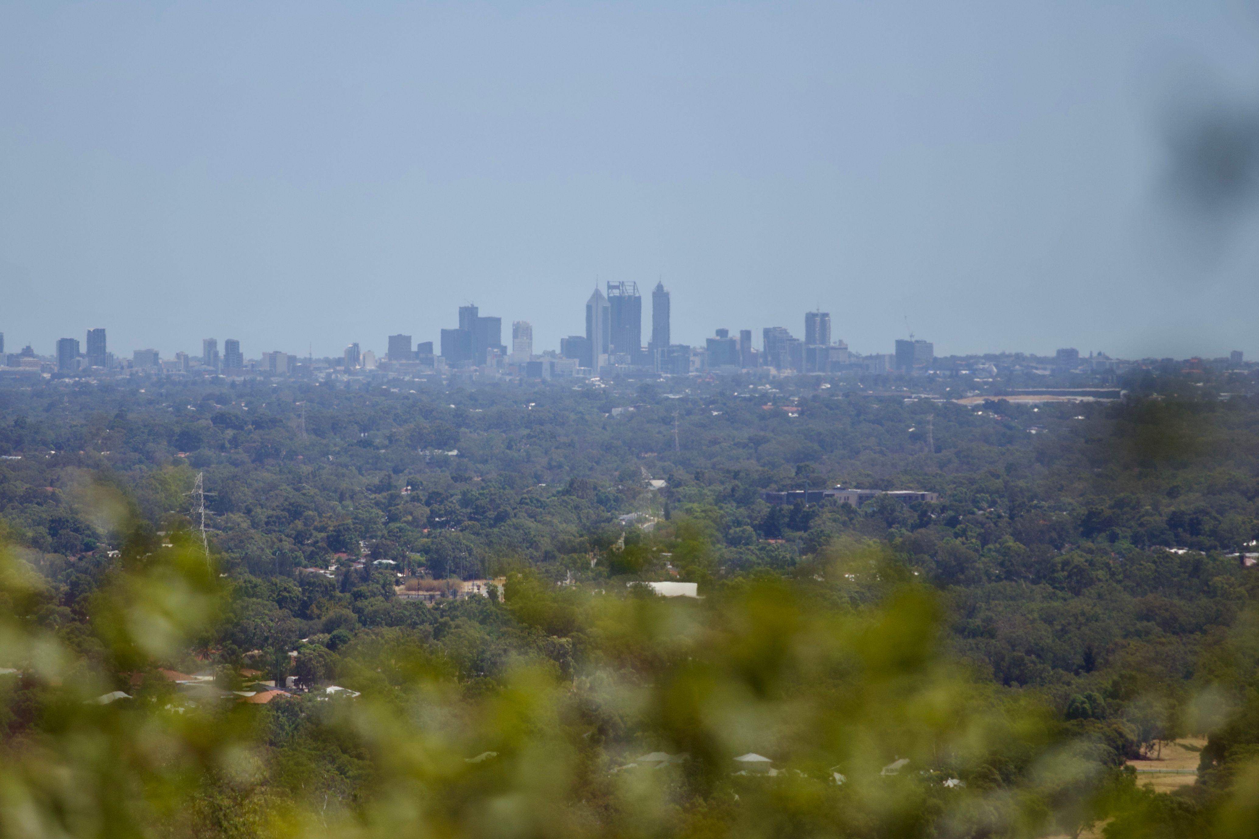 A hazy sky envelops Perth's metro area from a high vantage point