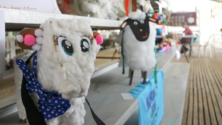 A row of fake sheep made out of different art resources.