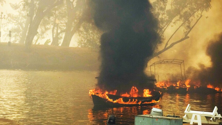 A boat burns on a lake