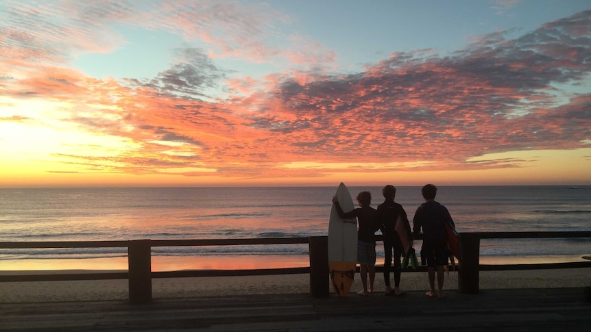 Kids watching the sunrise with surfboards good generic