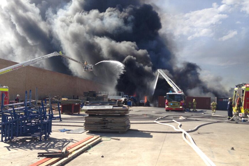 Firefighters battle a large blaze at a factory fire in Sydney's south-west