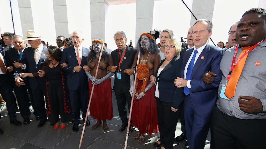 Politicians and indigenous leaders link arms for the No More anti-domestic violence campaign at Parliament House in Canberra.