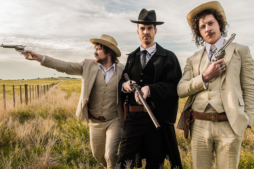 Adam and Reuben of Peking Duk and Al Wright of Cloud Control dressed as cowboys for the 2018 video Reprisal