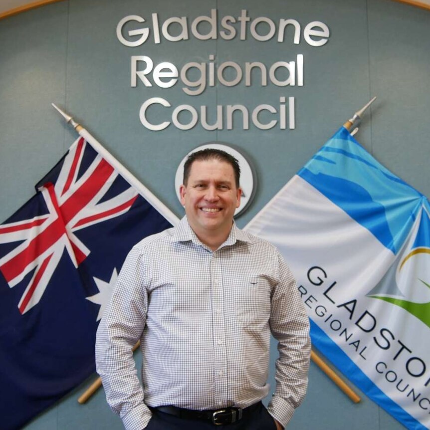 A man with short dark hair stands in front of a Gladstone Regional Council sign.