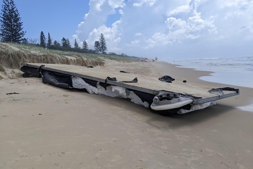 Large river pontoon stuck on a beach with polystyrene sticking out underneath