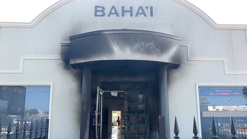 A blackened door and portico of a building