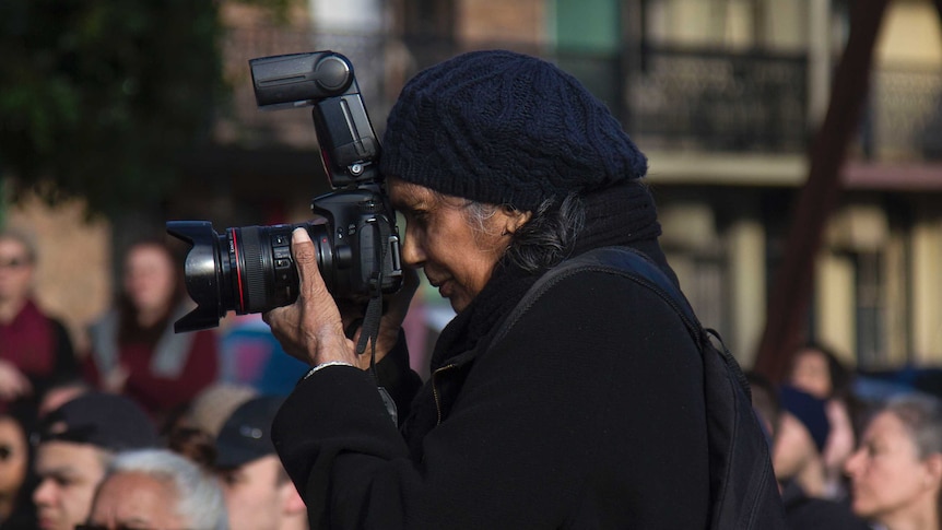 Barbara McGrady taking a shot with her camera.