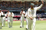Nathan Lyon leads the Australian team off the field as he waves to the crowd