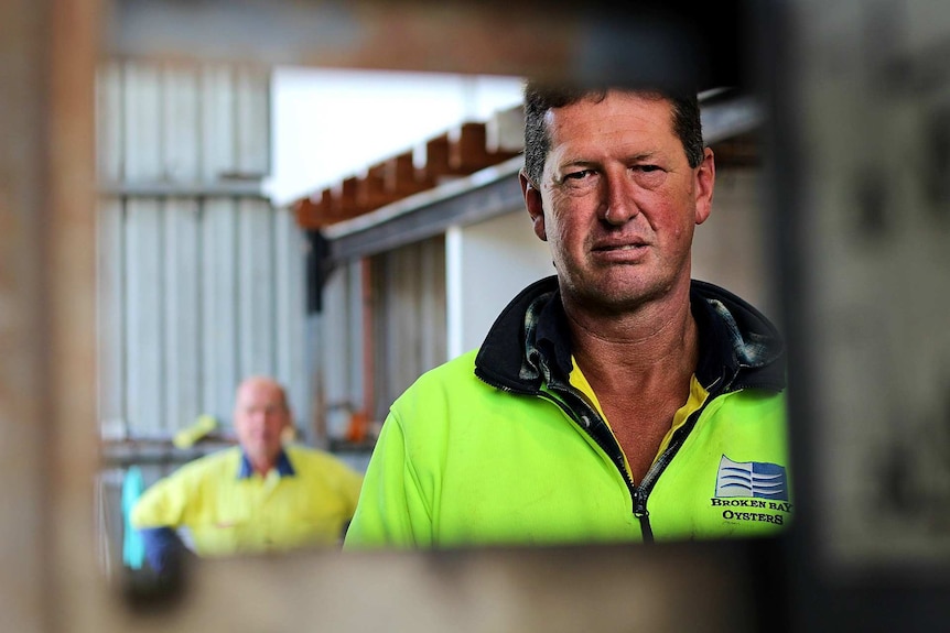 man in high-vis clothing looking intensely into camera