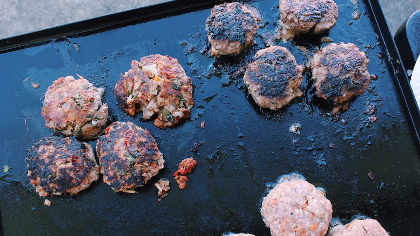 beef patties on a barbeque