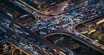 Traffic banked up on crossing motorways at night time.