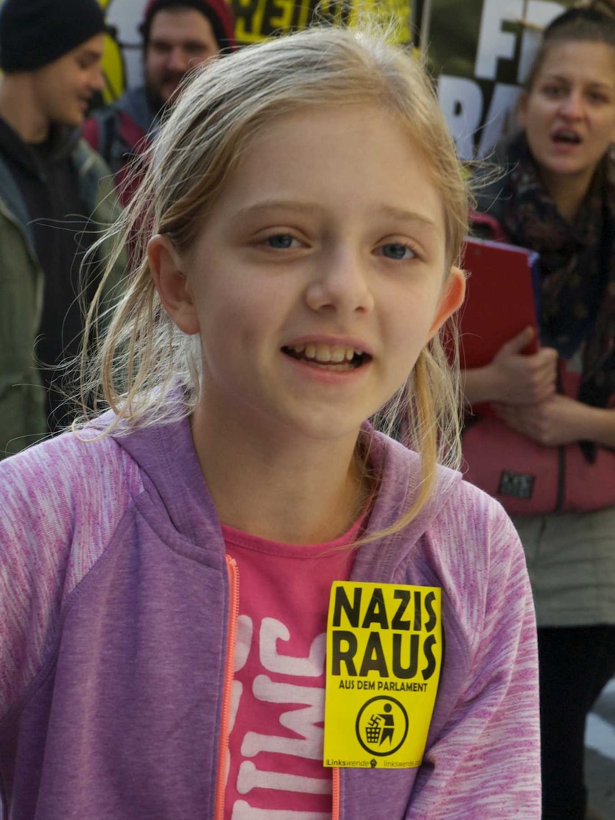 Girl with 'Nazis Out' sign