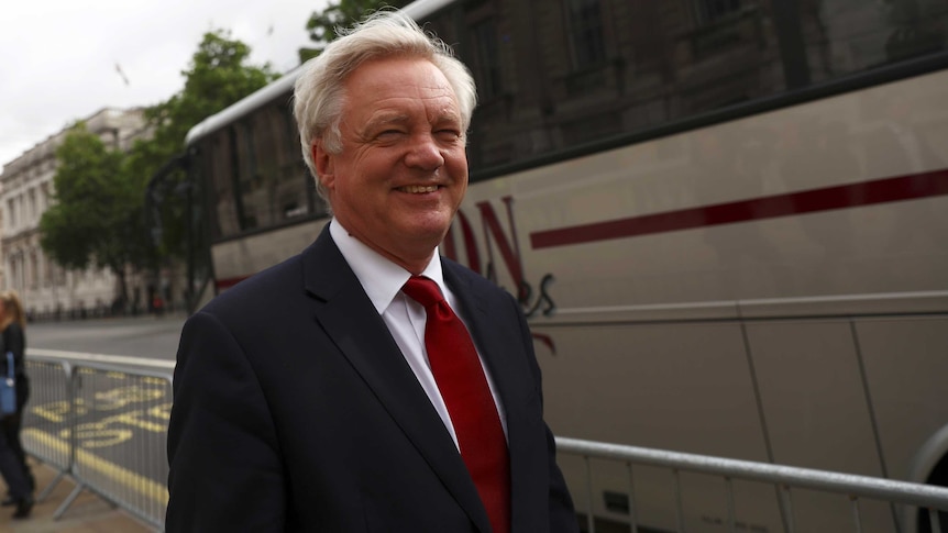 David Davis smiles as he walks out of the Cabinet office in Westminster.