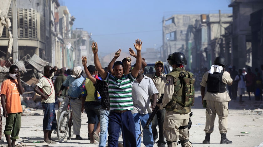 Haitian police have arrested suspected looters in a street in Port-au-Prince.