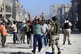 Haitian police have arrested suspected looters in a street in Port-au-Prince.