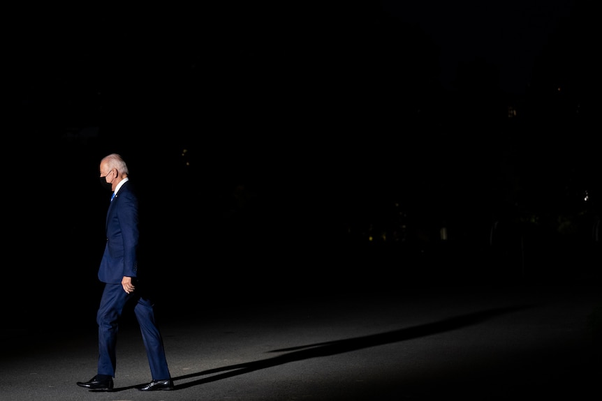 President Joe Biden walks into the White House after arriving on the South Lawn aboard Marine One