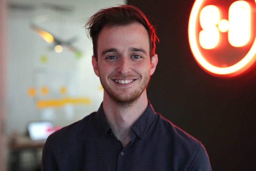 A head and shoulders shot of a smiling young man.