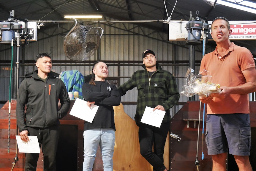 Four men standing at record awards ceremony