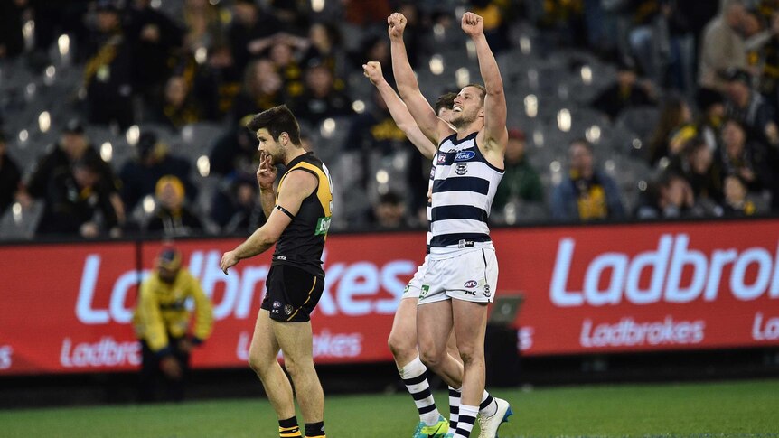 Sam Menegola (right) of the Cats and Richmond's Trent Cotchin react on the final siren at the MCG.