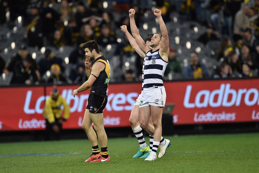 Sam Menegola (right) of the Cats and Richmond's Trent Cotchin react on the final siren at the MCG.