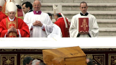 Cardinal Ratzinger looks on as pallbearers lift the coffin of late Pope John Paul II