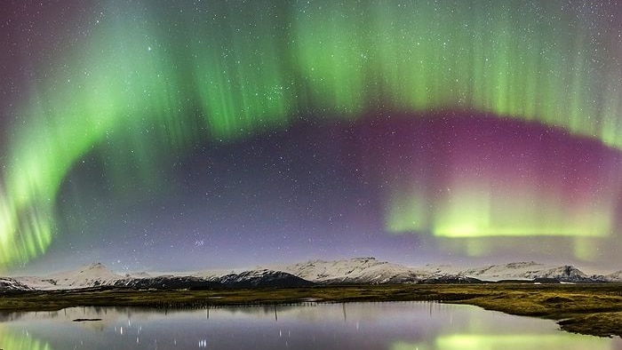 Aurora borealis or northern lights shimmering in southern Iceland