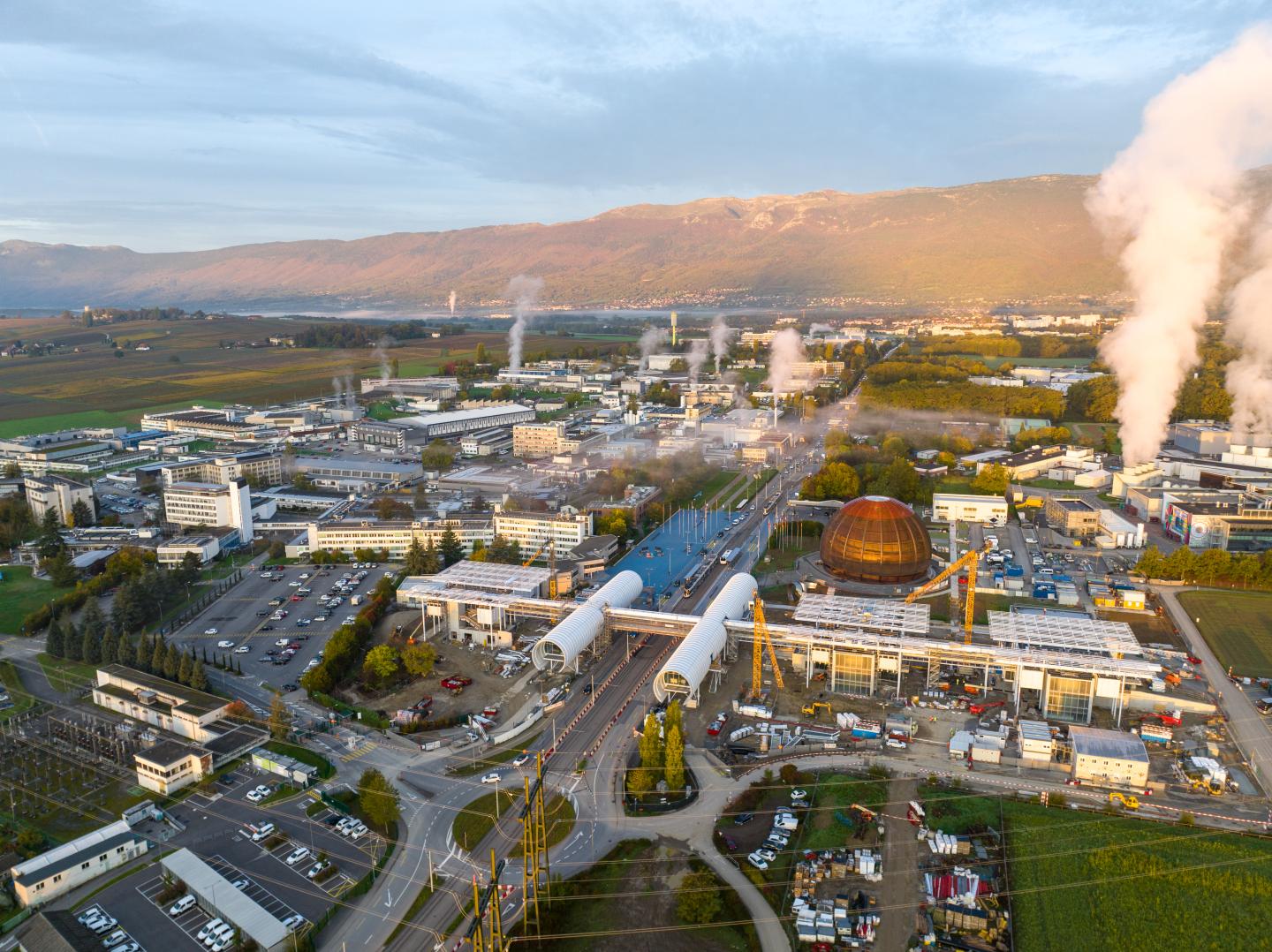 A drone picture showing the immense size of the CERN complex, with mountain ranges beyond