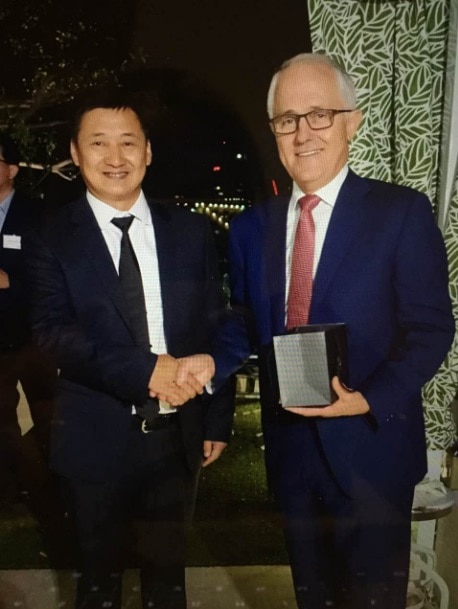 Malcolm Turnbull shakes hands with Liu Xiaodong. Mr Turnbull is holding a box in his hand