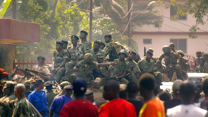 Guinean soldiers on armoured vehicles patrol the streets of Conakry on December 23, 2008.