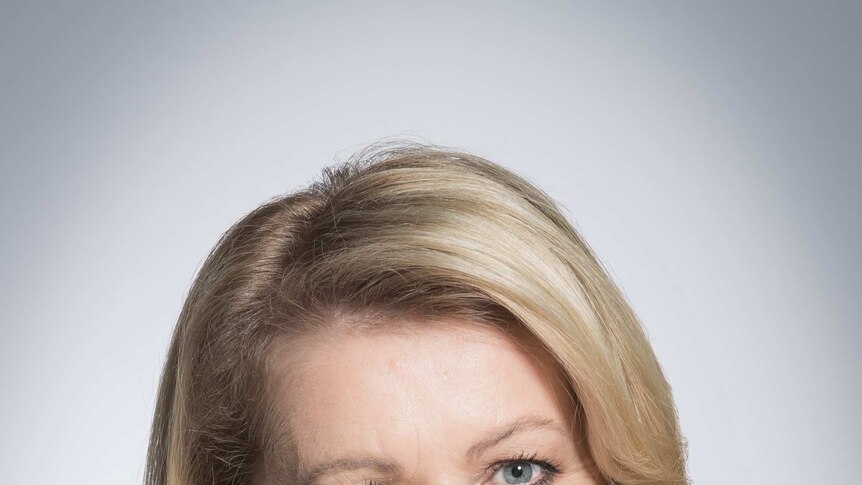 A  professional headshot of a woman