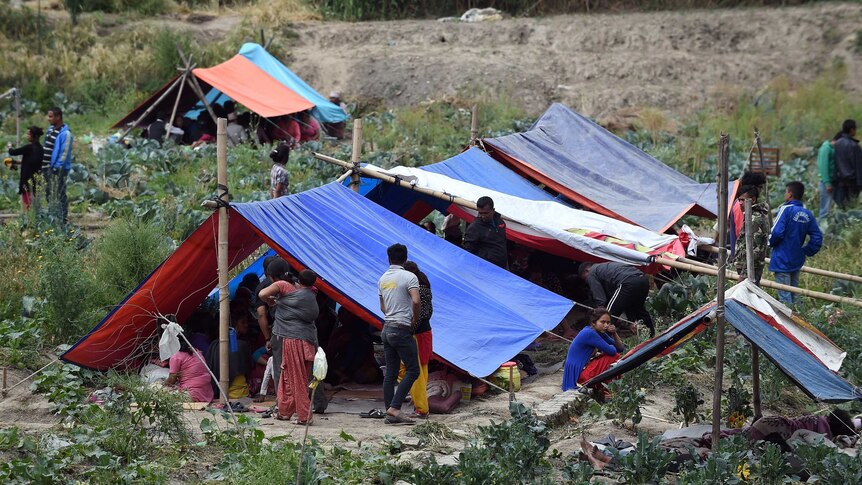 Nepalese people stay outside in tents on the outskirts of Kathmandu following the quake.