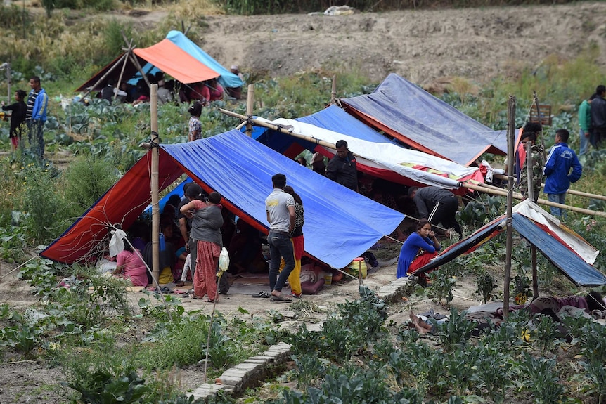 Nepalese people stay outside in tents on the outskirts of Kathmandu