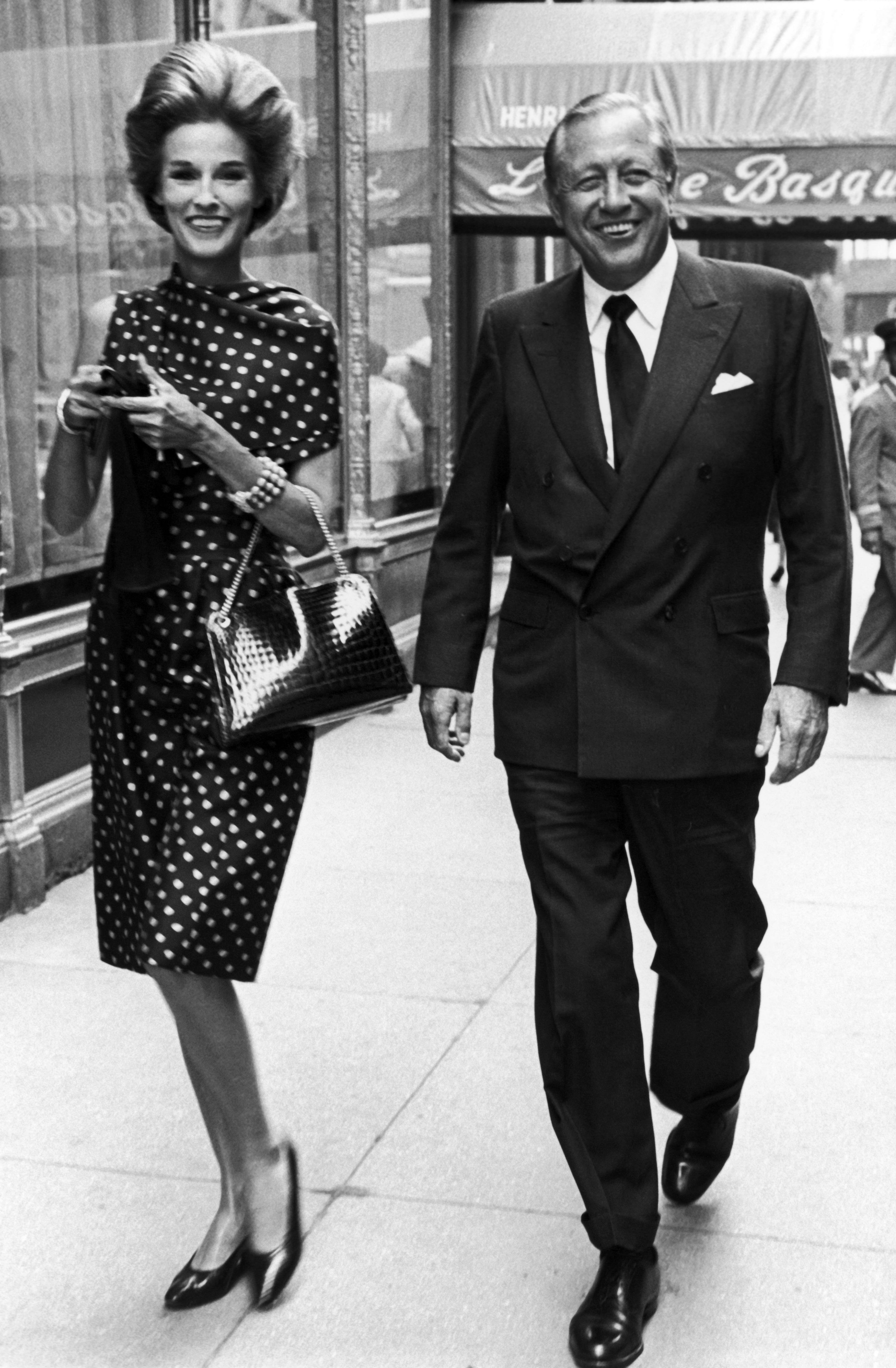 Black and white photo of William and Babe Paley walking 