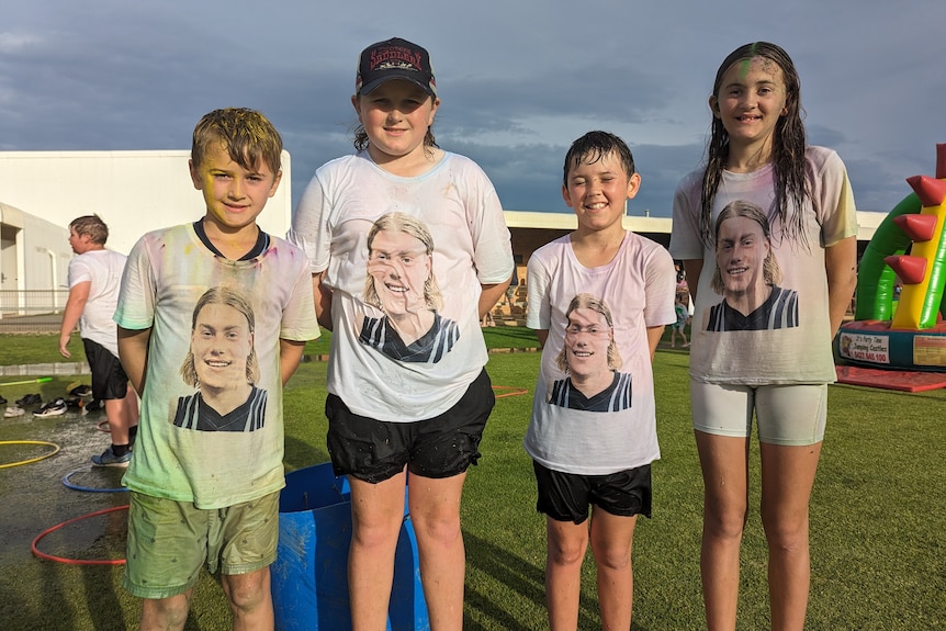 Four kids all wearing white shirts with the face of football player Harley Reid 