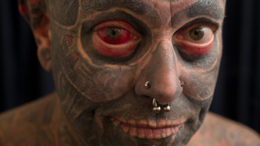 Tattboy had his right eyeball tattoed red.