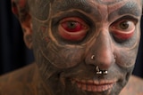 Tattboy had his right eyeball tattoed red.
