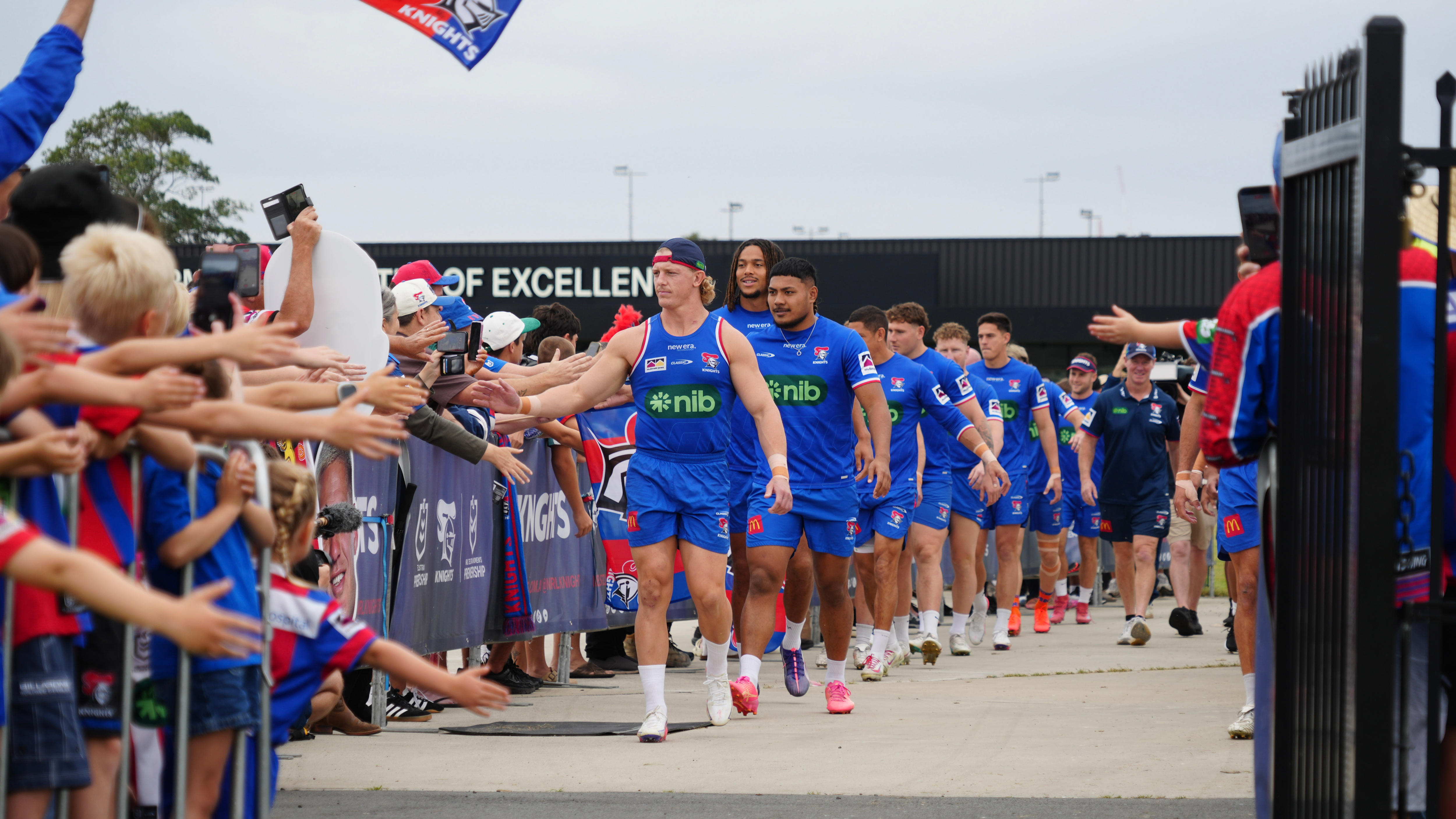 a rugby league team hi-fiving fans