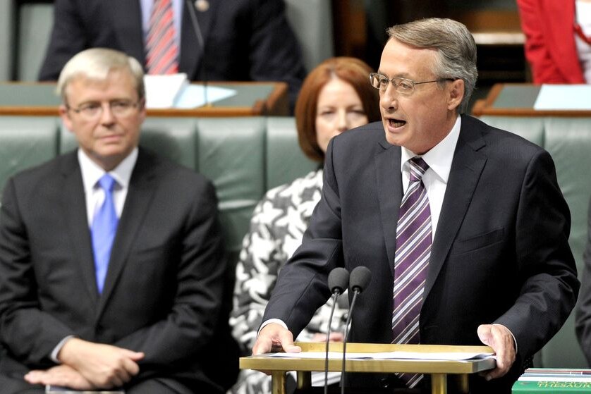 Prime Minister Kevin Rudd and deputy Julia Gillard listen to Federal Treasurer Wayne Swan