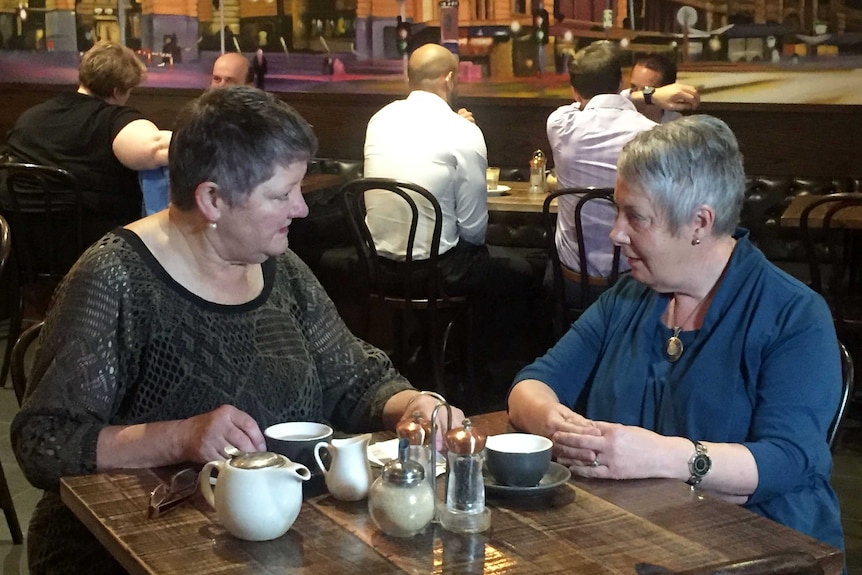 Anne MacBean (left) at a cafe table with Anita Smith of Seniors Rights Victoria.