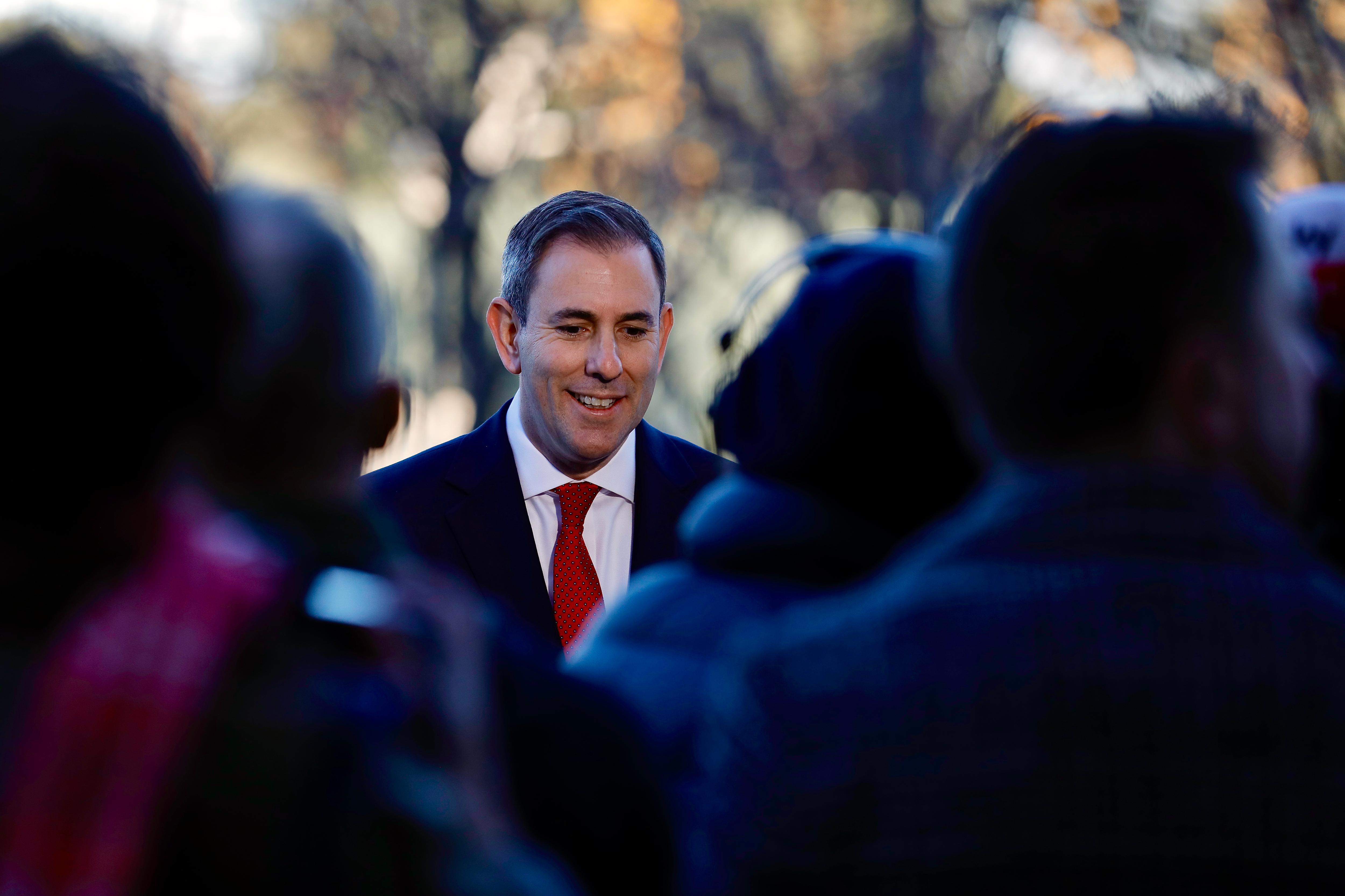  Jim Chalmers holds a copy of the 2024 Budget papers as he arrives at Parliament House.